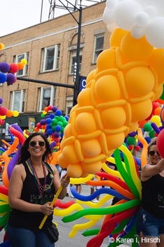 Female carrying balloons forming an ice cream cone